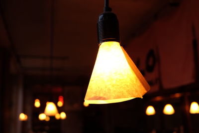 Low angle view of illuminated lamp post at night