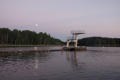 Scenic view of lake against sky at dusk