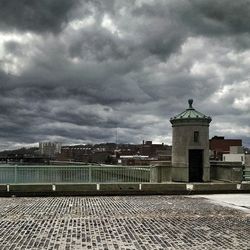 Buildings against cloudy sky