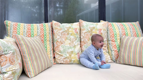 Cute girl sitting on sofa at home