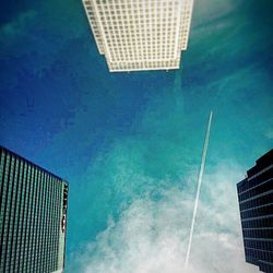 Low angle view of modern building against blue sky