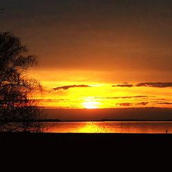 Scenic view of sea against orange sky