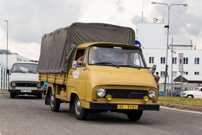 View of vehicles on road along buildings