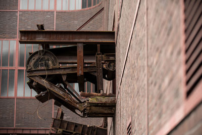 Tilt image of telephone booth against built structure