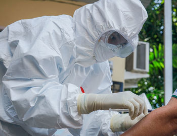 Midsection of man with umbrella