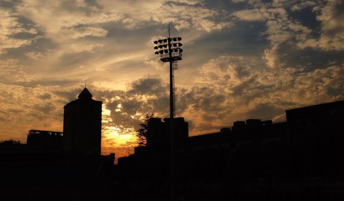 Silhouette buildings against sky during sunset