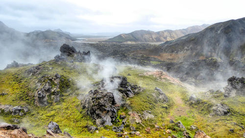 Scenic view of volcanic rock formations against sky