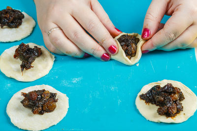 Cropped hand of woman holding food