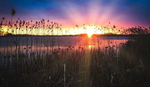 Scenic view of lake against romantic sky at sunset