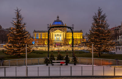 Illuminated building against sky at night