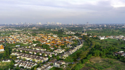 High angle view of buildings in surabaya city against sky