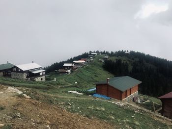 Houses on field against sky