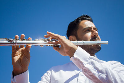 Midsection of man playing violin