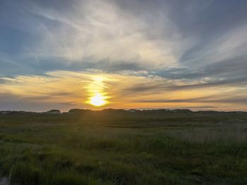 Scenic view of field against sky during sunset