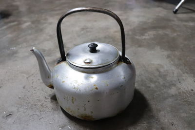 High angle view of old kettle on table