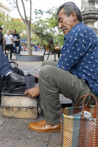 Portrait of young man sitting in market