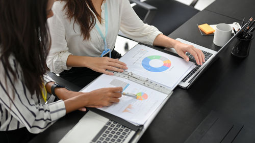 Midsection of business colleagues working at office