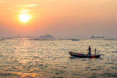 Boat on calm sea at sunset