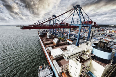 Large container port with ship moored at quai-side