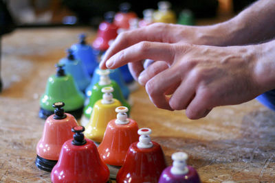 Cropped hands pressing bells at table