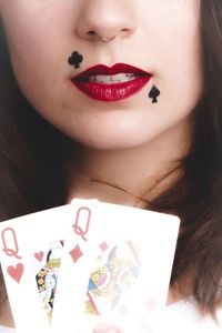 Cropped image of woman with playing cards