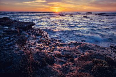 Scenic view of sea against sky during sunset
