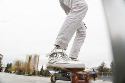 Legs of mature man on skateboard