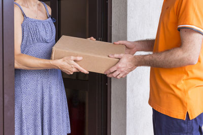 Midsection of couple holding hands