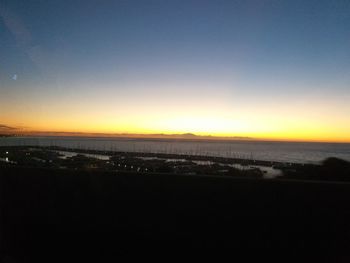 Scenic view of sea against clear sky during sunset