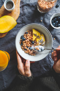 Cropped hands having breakfast at home