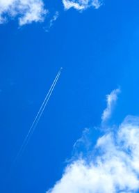 Low angle view of vapor trails in sky