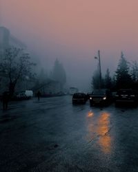 Cars on road in city during winter