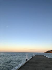 Scenic view of sea against clear sky during sunset