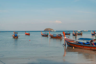 Boats in sea against sky