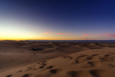 Scenic view of desert against sky during sunset