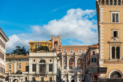 Low angle view of buildings against blue sky