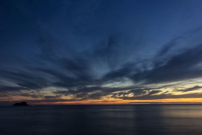 Scenic view of dramatic sky over sea during sunset