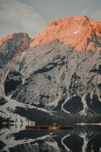 Scenic view of lake by mountains against sky