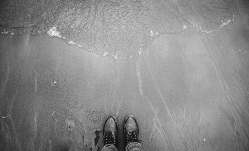 Low section of person standing on water