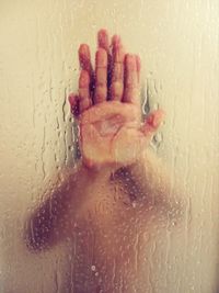 Close-up of wet glass in bathroom