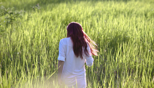 Woman standing on grassy field