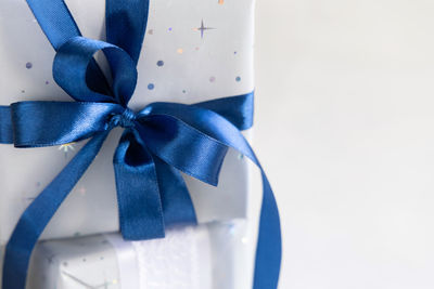 Close-up of blue tied on white background