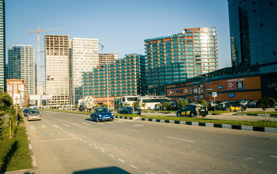 City street and modern buildings against clear sky