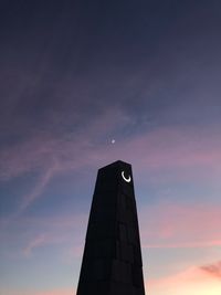 Low angle view of tower against sky during sunset