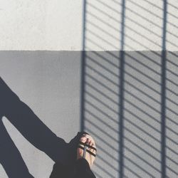 Low section of woman standing on tiled floor