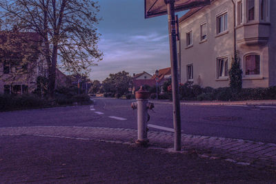 Road by building against sky in city