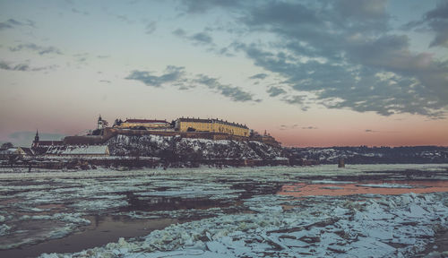 Buildings against cloudy sky during winter