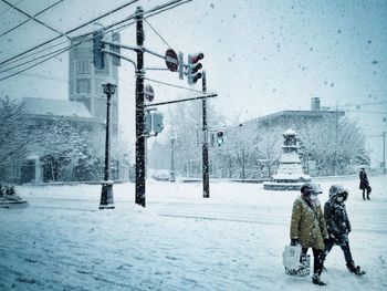 Woman standing on snow covered landscape