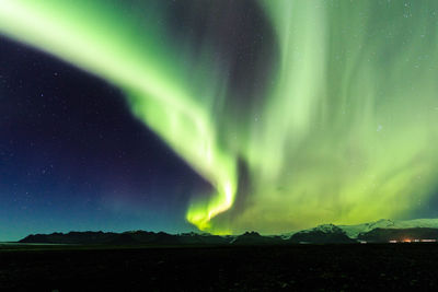 Scenic view of landscape against sky at night