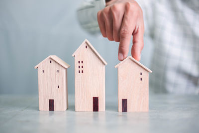 Close-up of hand with toy on house in building